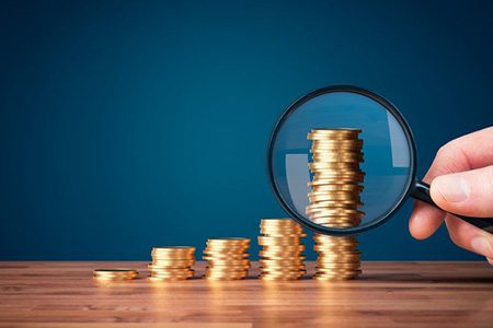 Coins examined with magnifying glass