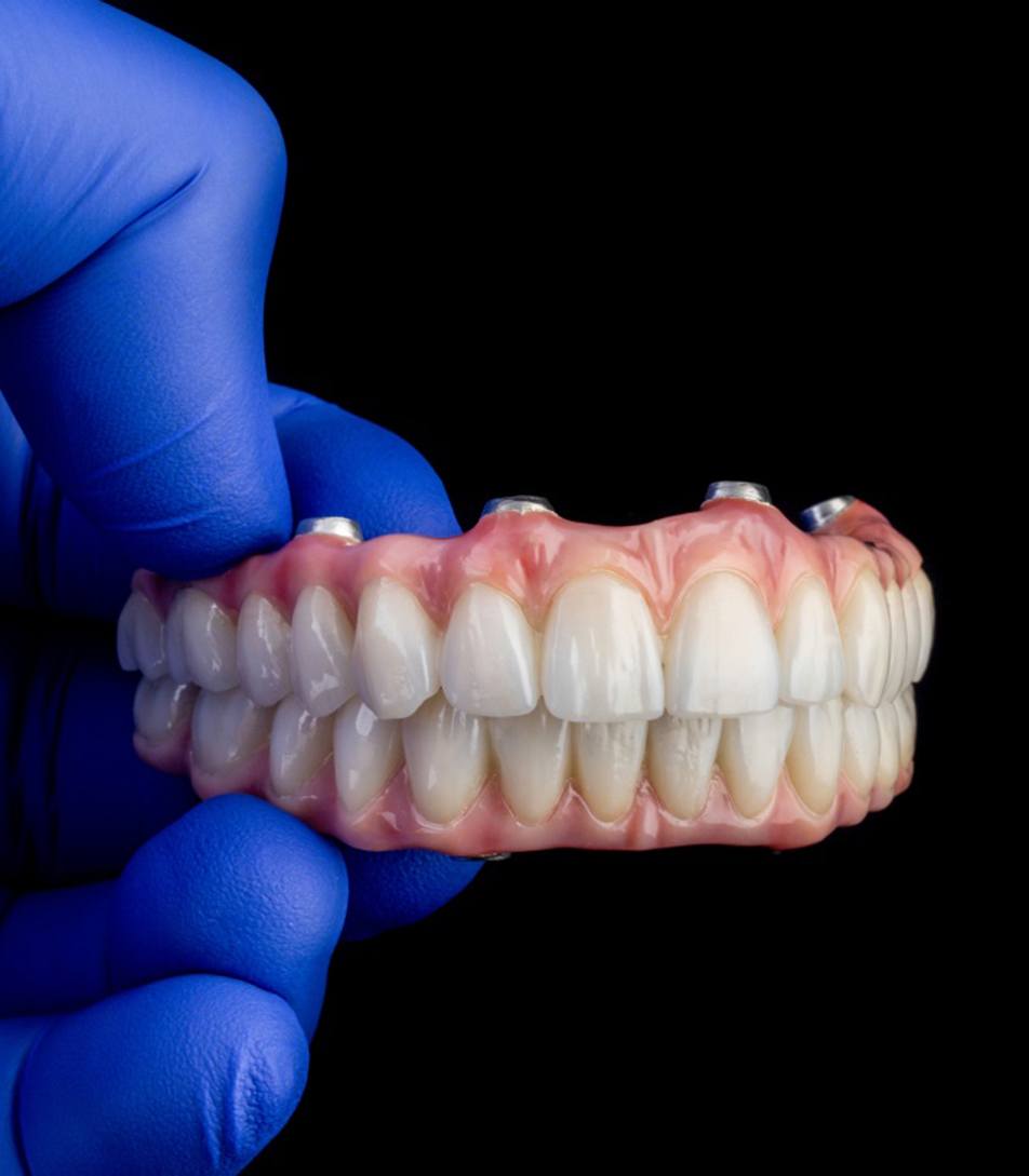 Full dentures next to dental mirrors