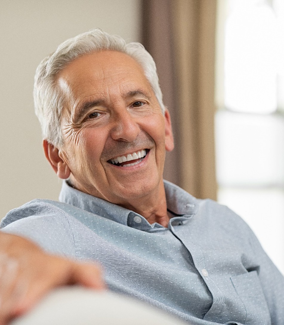 man smiling while sitting on couch