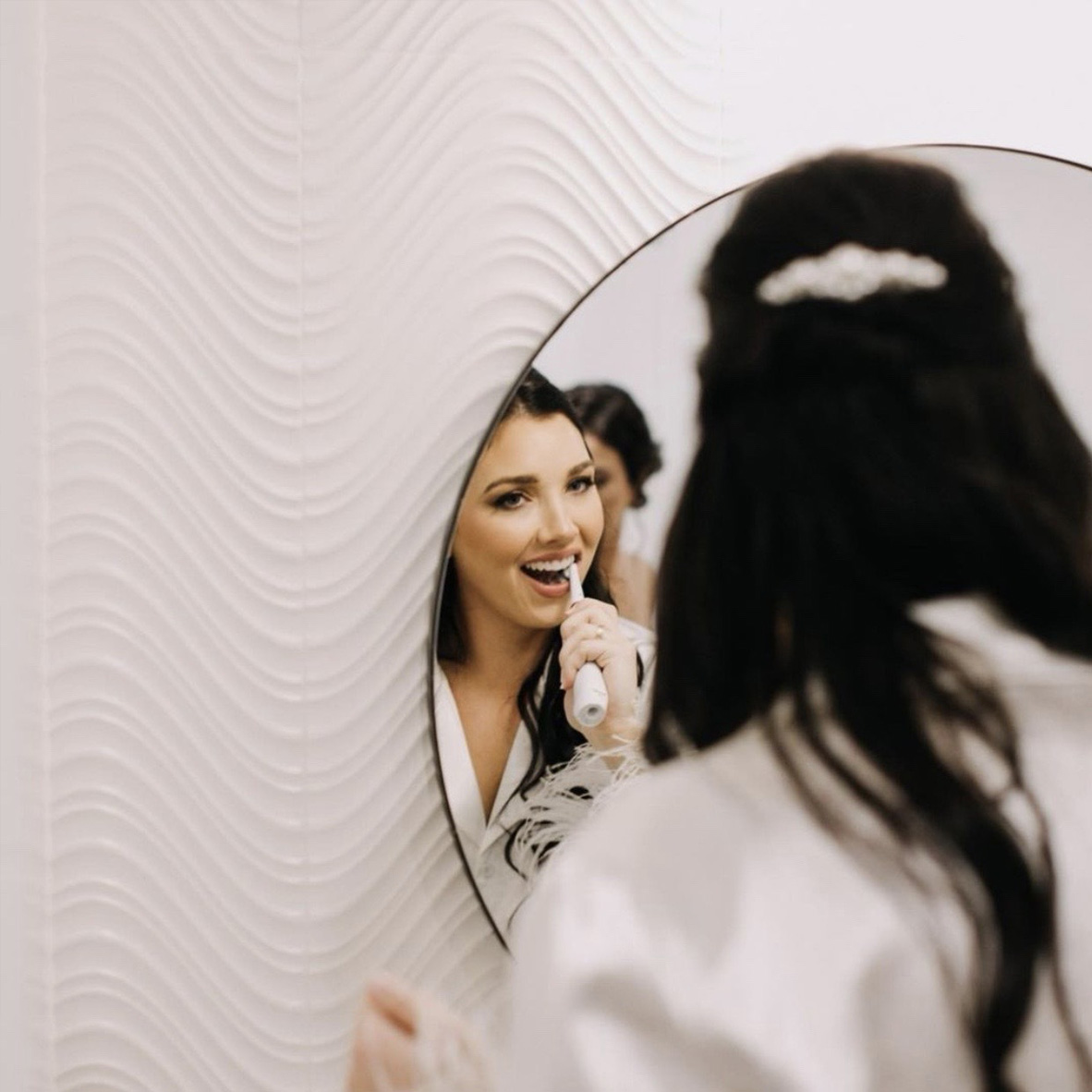 Woman brushing teeth in Royal Palm Beach dental office