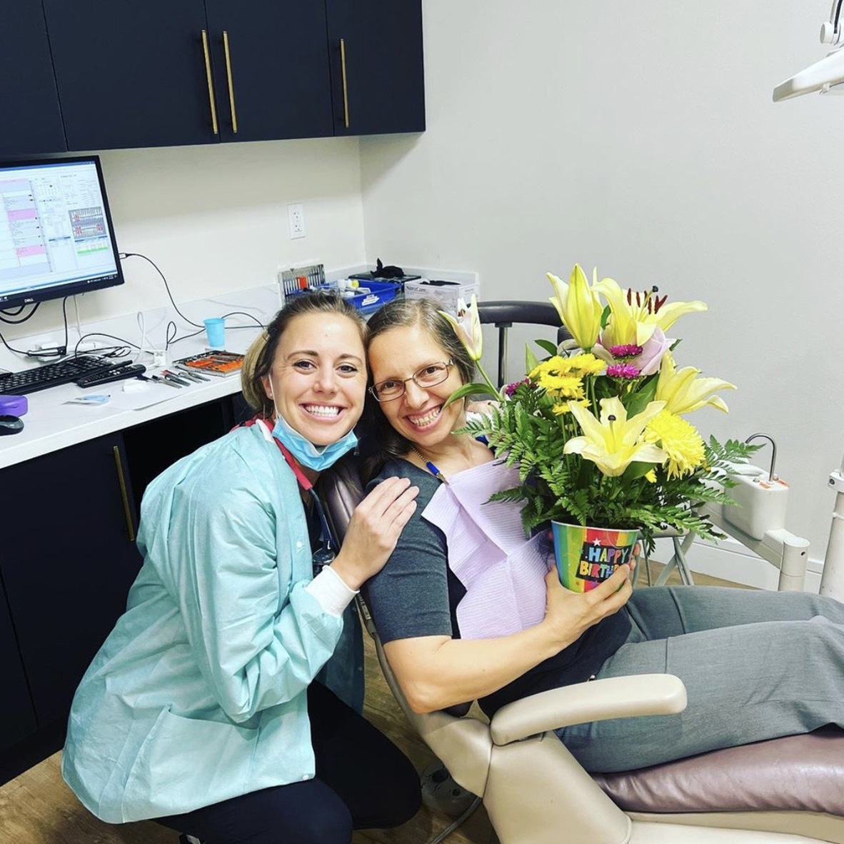 Dental team member giving dentistry patient a plant in Royal Palm Beach