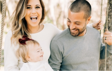 Doctor Civetti her husband and daughter on a swing