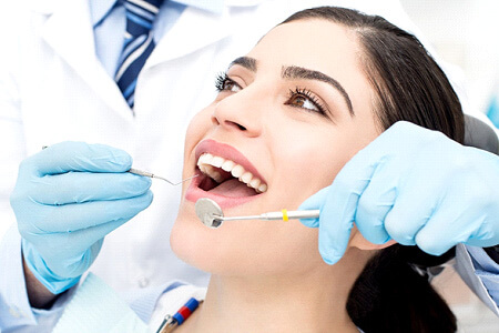 woman visiting dentist for checkup