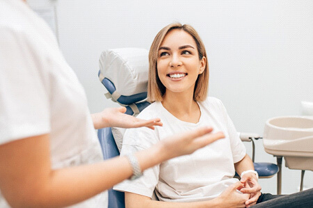 woman smiling while talking to dentist