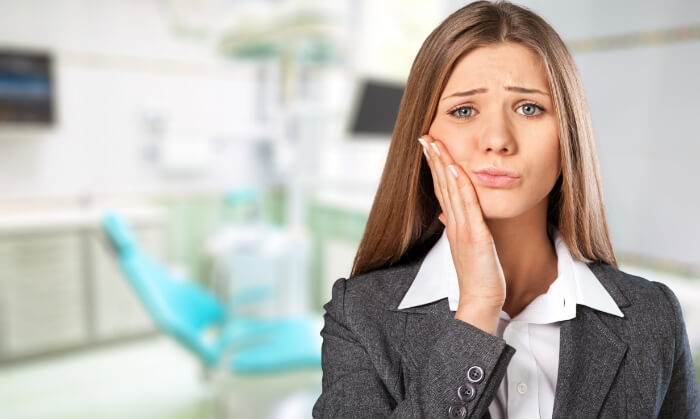 Woman in pain before gum disease treatment