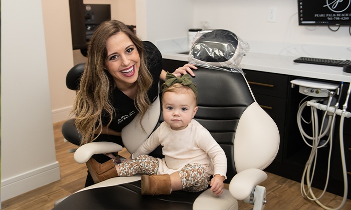 Royal Palm Beach Florida dentist and baby in dentistry exam room for dental services
