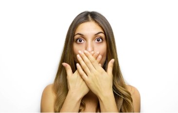 Woman covering her mouth before gum disease treatment