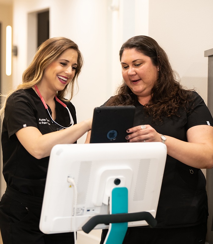 Dentist and dental team member looking at intraoral camera images