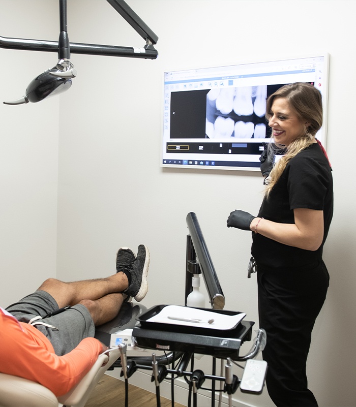 Dentist and dental patient looking at all digital x rays