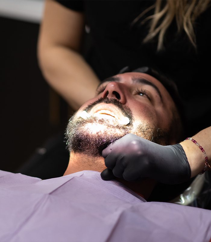 Dentist performing equilibration and occlusal adjustments