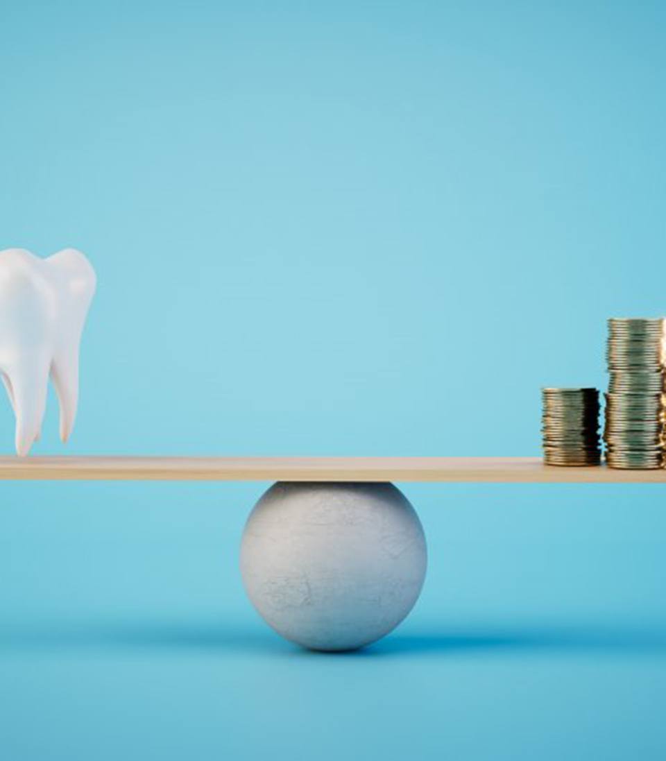 a tooth balancing with a stack of coins