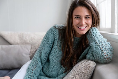 a woman smiling with bright teeth at home