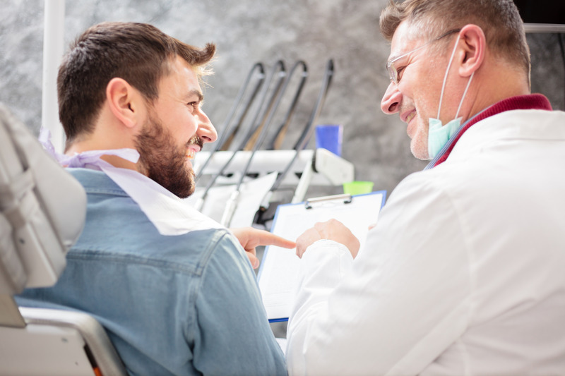 Patient talking to dentist about dental implants