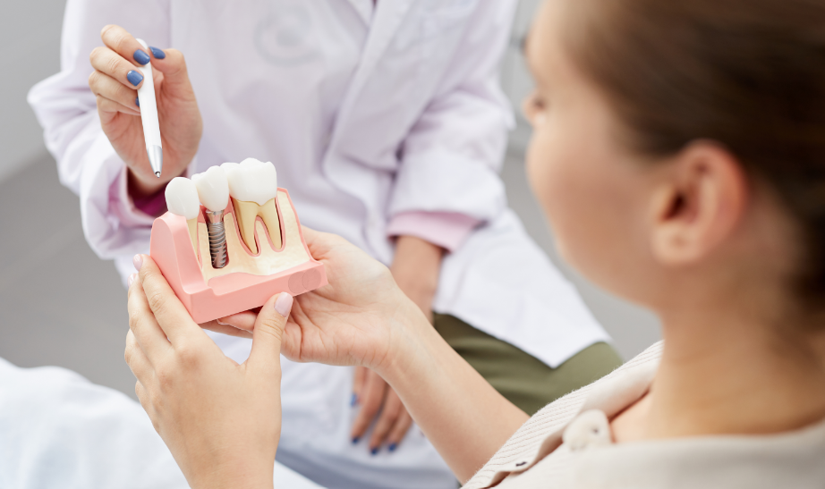 Dentist showing patient dental implant mold